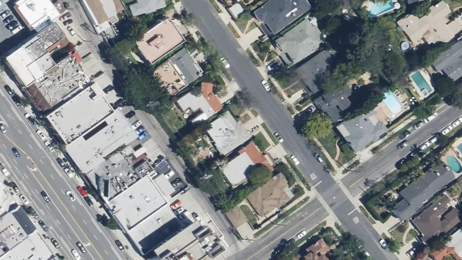 Satellite view: an apartment building among many on one street